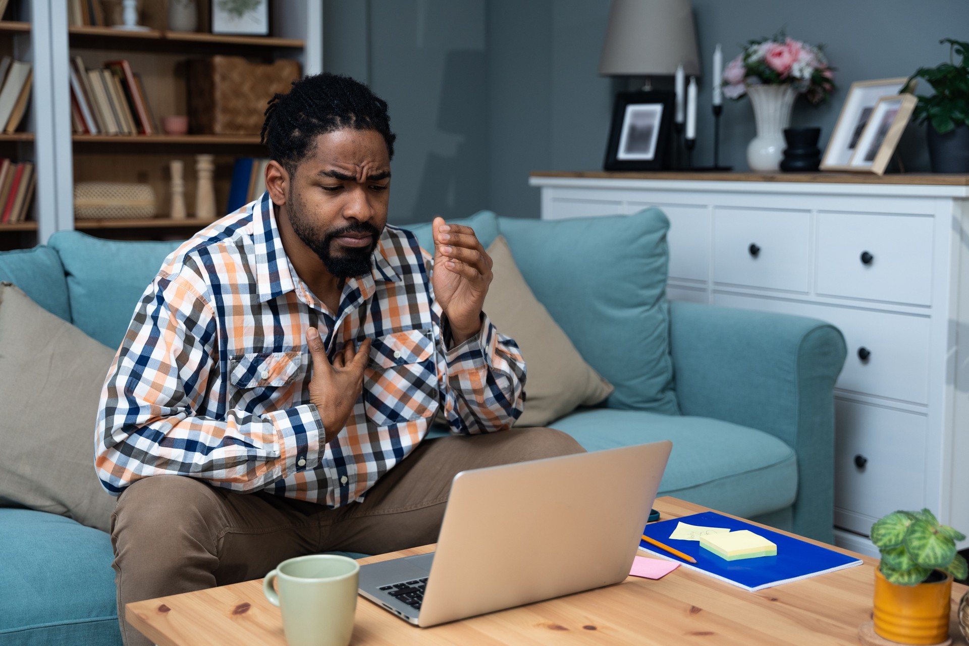 Young black African American man talking on video call with his psychotherapist doctor after online therapy sessions, happy that he is well and mentally health now after telemedicine conversations.